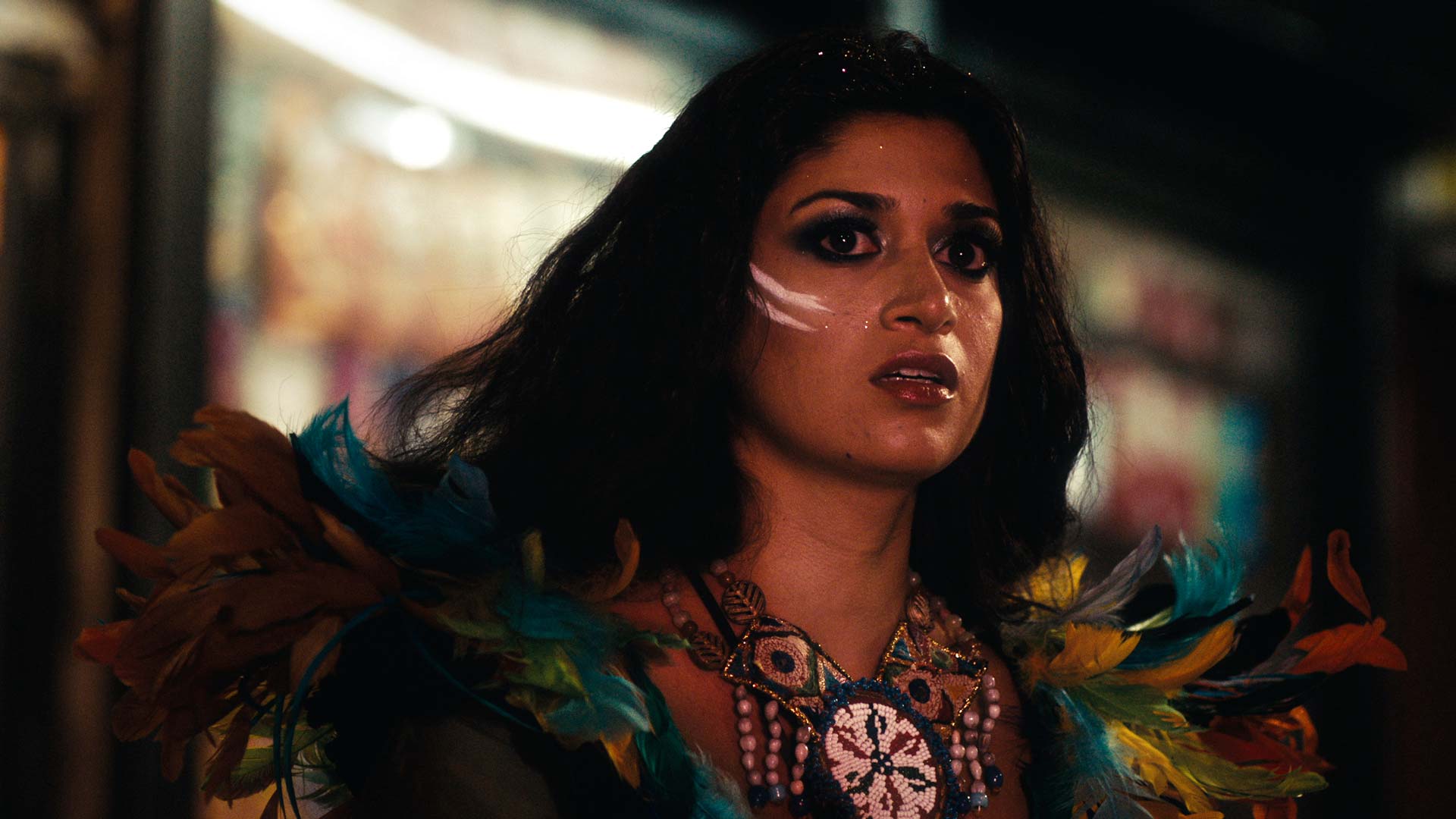 woman with war paint and colourful dress like bird