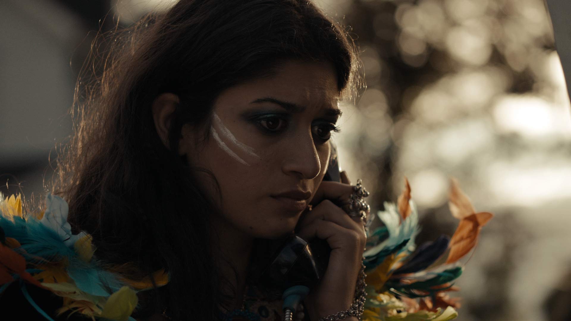 woman staring forward with war paint makeup