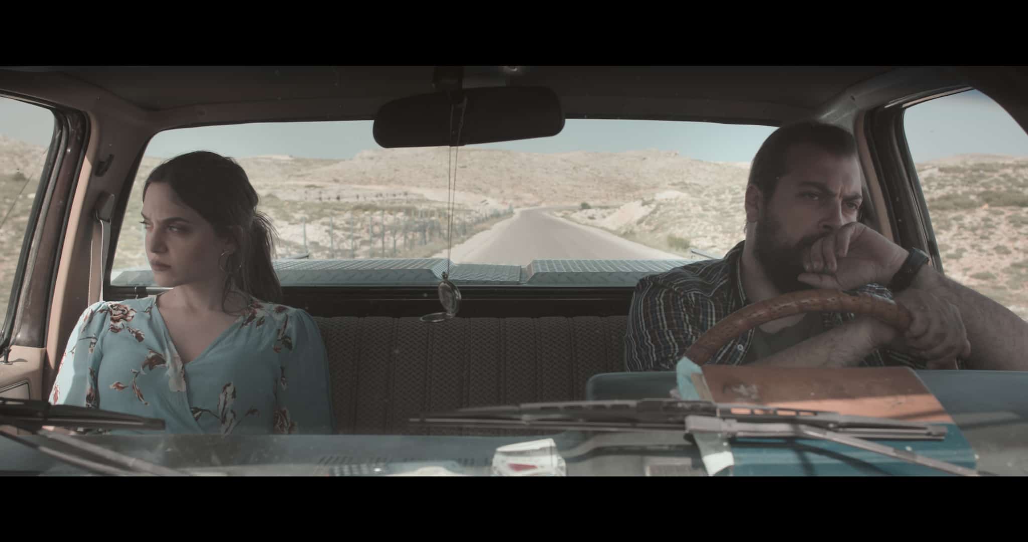 couple in car looking in opposite directions