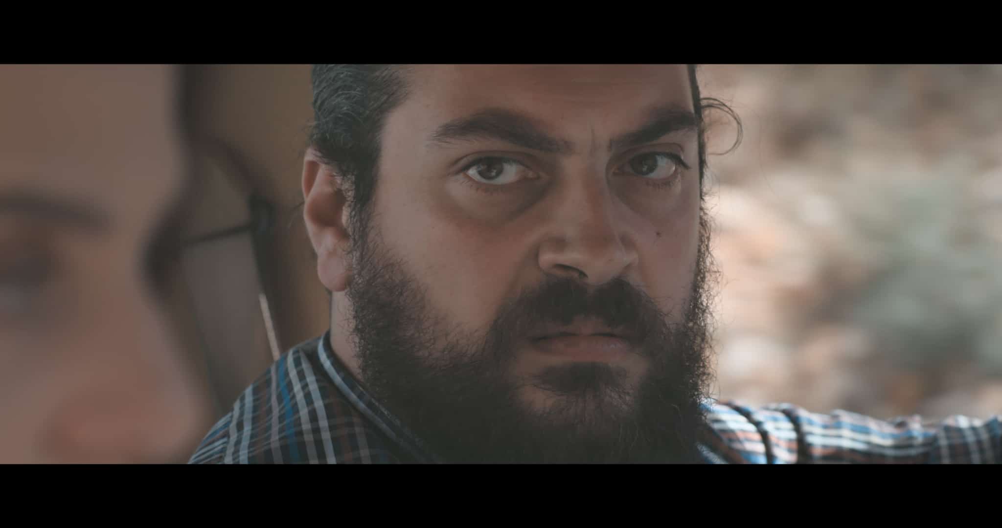 angry looking man in car