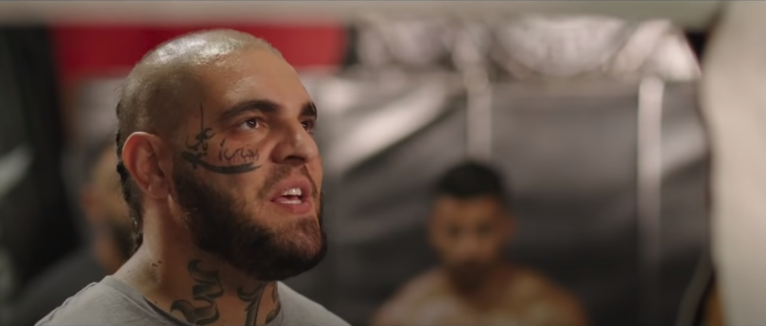 aggressive looking man with face tattoos