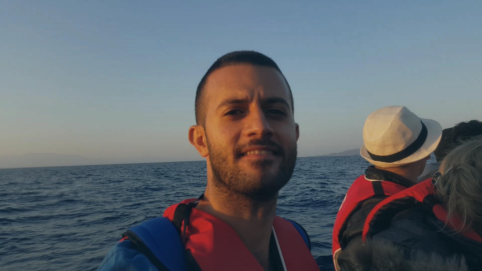 headshot of a man by the ocean