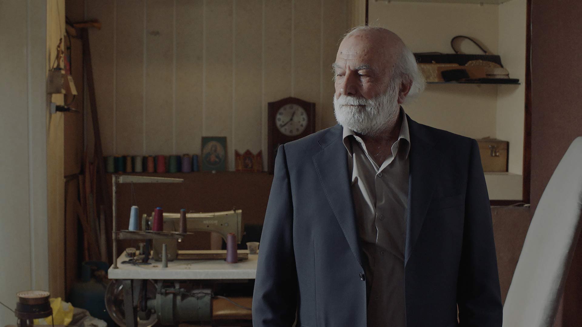 Old bearded man looking wise in a study