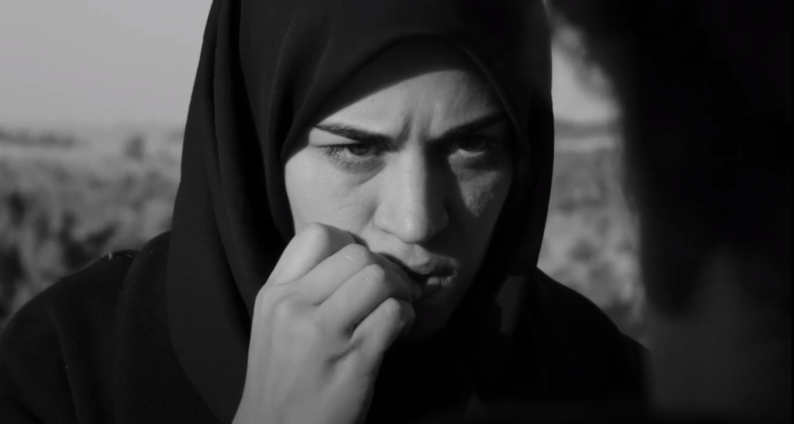 woman in burka biting her nails