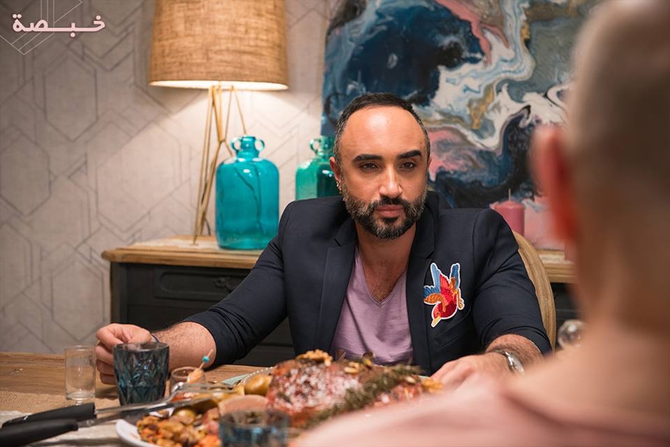 man in suit at dinner table