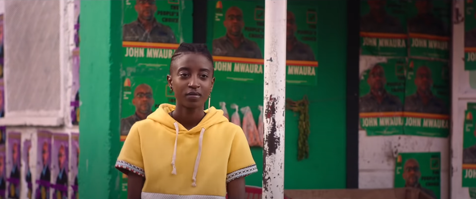 girl in yellow sweatshirt walking down the street