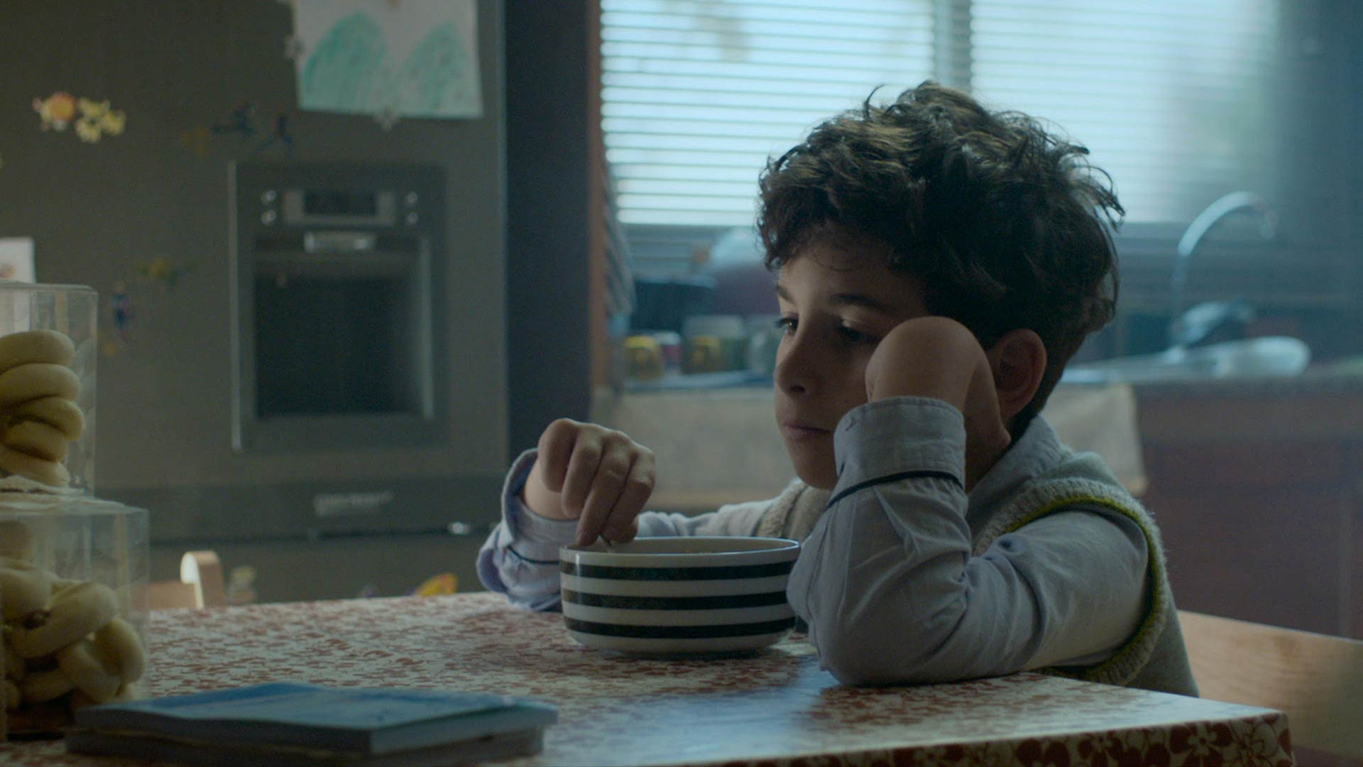 child eating breakfast with noone around